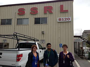 Elyse, Aaron, and Aggi outside Building 120 for safety training.  